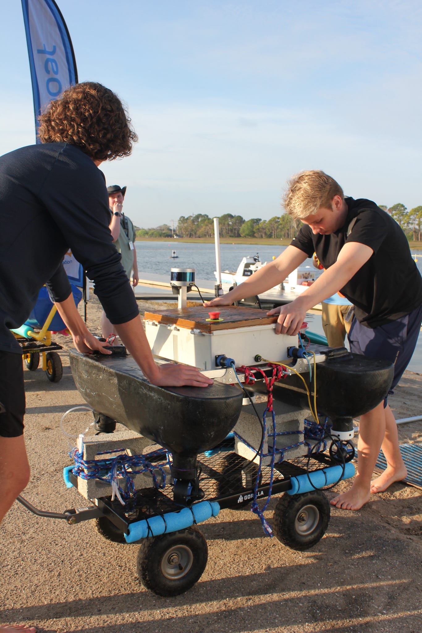Roboboat members preparing the hull for launch at competition