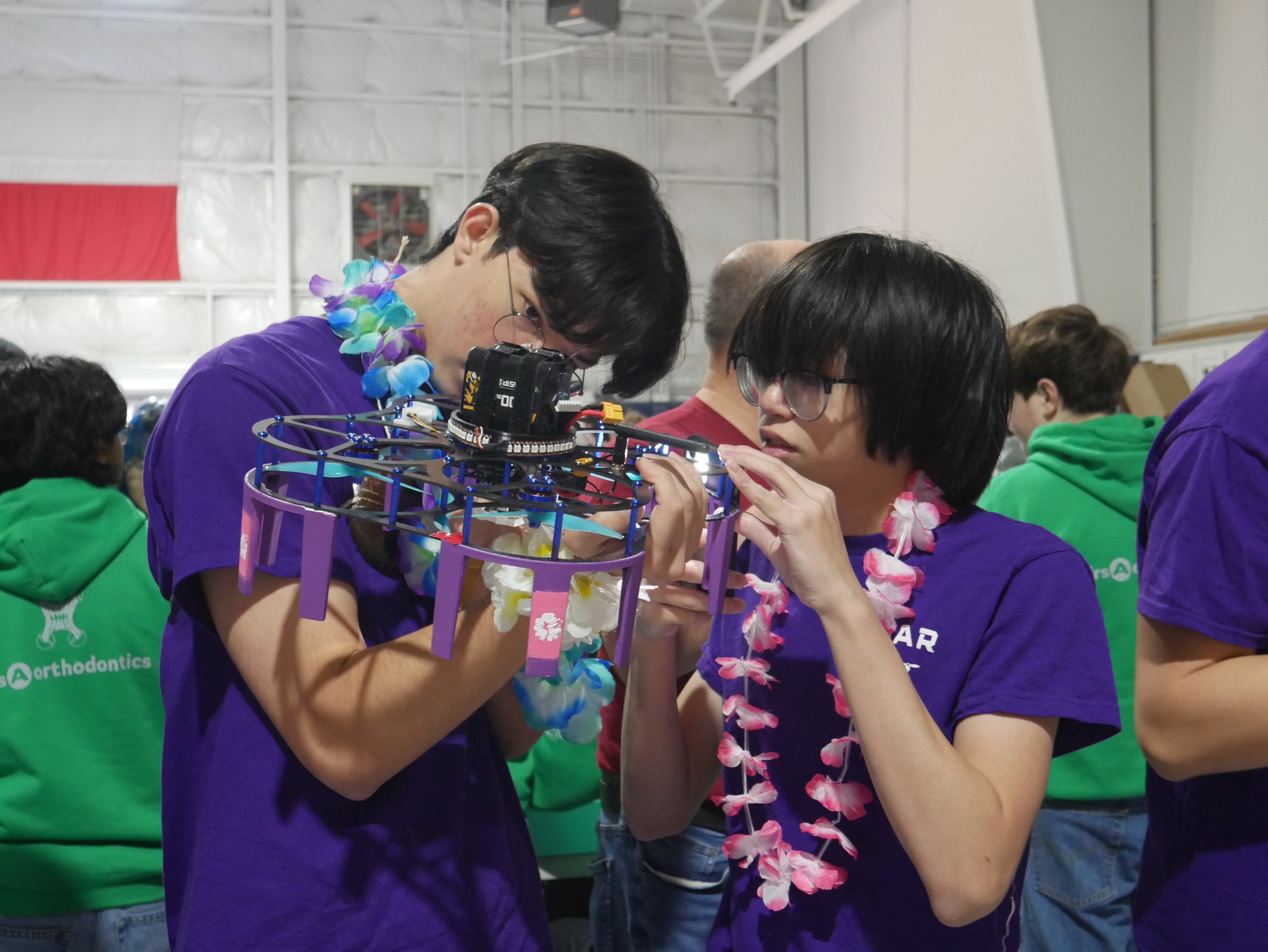 Students inspecting a drone airframe before a run